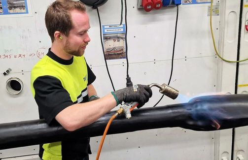 Heating up heat shrink tube for final installation of joint